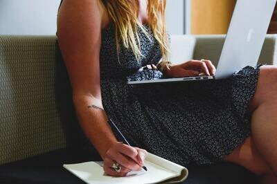 selecting hrms - woman making list with laptop